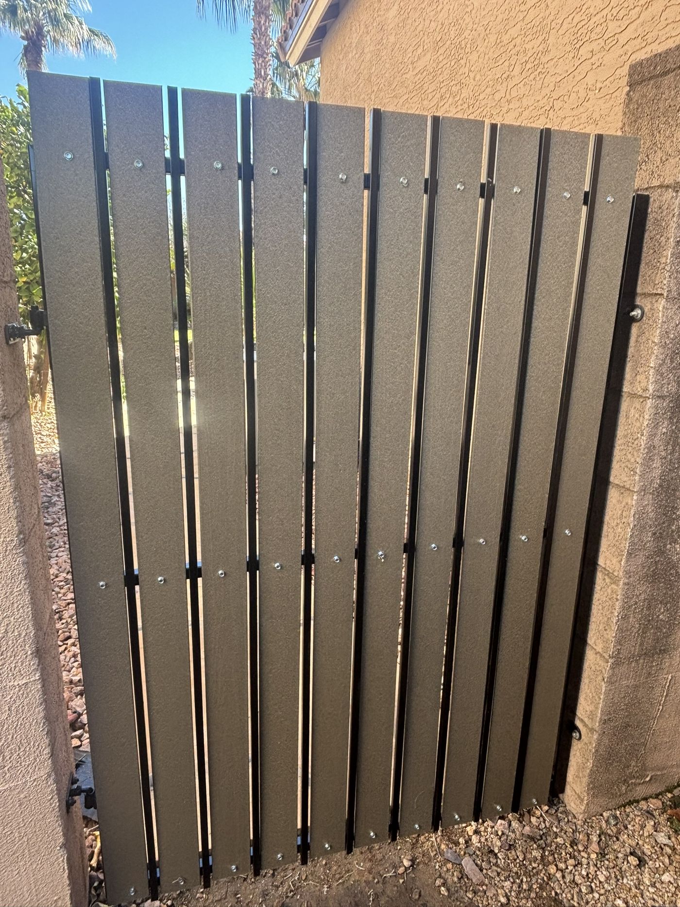 Gate after refurbishment with modern grey slats and new hardware